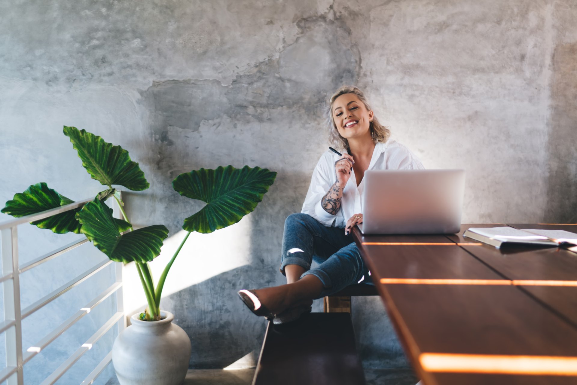 Woman smiling while working on a laptop