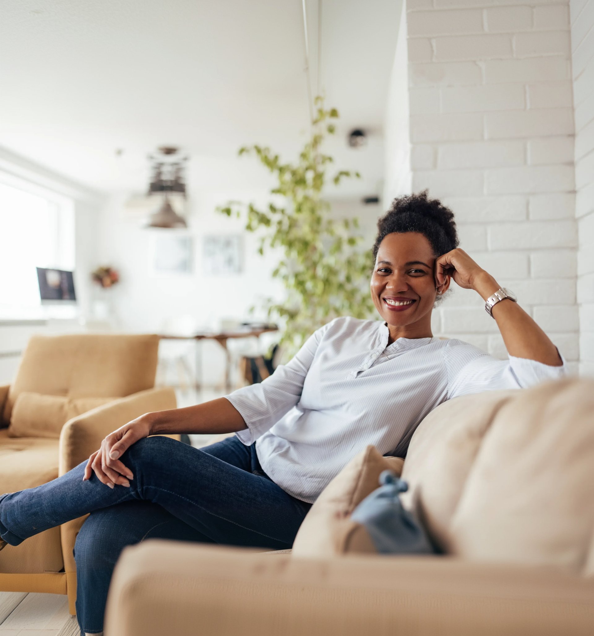 Smiling woman relaxing on a sofa